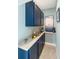 Built-in wet bar with blue cabinets, granite countertop, and ample storage at 13838 Begonia Cir, Port Charlotte, FL 33981