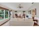 Spacious living room featuring hardwood floors, ample natural light, and a ceiling fan at 14080 Willow Glen Ct # 233, Port Charlotte, FL 33953