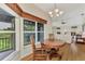 Bright dining room with a round table, hardwood floors and large windows at 14080 Willow Glen Ct # 233, Port Charlotte, FL 33953