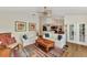 Living room with hardwood floors, white sofas, and views into adjacent kitchen at 14080 Willow Glen Ct # 233, Port Charlotte, FL 33953