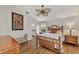 Main bedroom with wood flooring and access to private balcony at 14080 Willow Glen Ct # 233, Port Charlotte, FL 33953