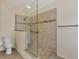 Walk-in shower with glass enclosure and tile surround at 14080 Willow Glen Ct # 233, Port Charlotte, FL 33953