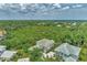 Aerial view of two houses with green roofs and a view of nature at 14080 Willow Glen Ct # 233, Port Charlotte, FL 33953