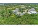 Aerial view of a community with houses nestled among trees and a golf course at 14080 Willow Glen Ct # 233, Port Charlotte, FL 33953