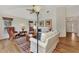 Open living room with hardwood floors, neutral color palette, and access to other rooms at 14080 Willow Glen Ct # 233, Port Charlotte, FL 33953