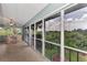 Extended lanai with a view of lush greenery and the sky at 14080 Willow Glen Ct # 233, Port Charlotte, FL 33953