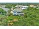 Aerial view of a house with a green roof and a landscaped yard at 14080 Willow Glen Ct # 233, Port Charlotte, FL 33953