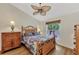 Bedroom with a ceiling fan, wood-look flooring and large window at 14080 Willow Glen Ct # 233, Port Charlotte, FL 33953