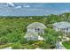 Aerial view of a house with a green roof and surrounding trees at 14080 Willow Glen Ct # 233, Port Charlotte, FL 33953