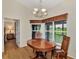 Charming dining room with wood table and access to a balcony at 14080 Willow Glen Ct # 233, Port Charlotte, FL 33953