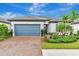 House exterior with gray garage door and brick driveway at 1445 Hyssop Loop, North Port, FL 34289