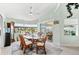 Bright dining room with glass-top table and rattan chairs, overlooking the pool at 15784 Melport Cir, Port Charlotte, FL 33981