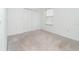 Empty bedroom with carpet flooring, a window, and closet at 19524 Fishhawk Trl, Venice, FL 34293