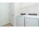 Bright laundry room, featuring washer and dryer, and ample shelving at 19524 Fishhawk Trl, Venice, FL 34293