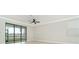 Bright bedroom with sliding door, neutral walls, crown molding and tile floors at 19536 Fishhawk Trl, Venice, FL 34293