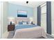 Cozy bedroom with blue accents, a plush bed, and stylish decor creates a calming and inviting atmosphere at 19536 Fishhawk Trl, Venice, FL 34293