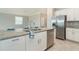 Kitchen island with granite countertops and stainless steel appliances at 19536 Fishhawk Trl, Venice, FL 34293