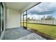 Relaxing screened patio overlooking the grassy backyard at 19536 Fishhawk Trl, Venice, FL 34293