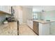 Kitchen featuring an island, stainless steel dishwasher and oven, plus granite counter tops at 19536 Fishhawk Trl, Venice, FL 34293