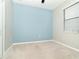 Bedroom with blue accent wall, beige carpet and a closet at 19536 Fishhawk Trl, Venice, FL 34293