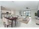 Open living space features a cozy living room, dining area and kitchen with barstool seating at 19536 Fishhawk Trl, Venice, FL 34293