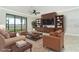 Cozy living room with comfortable furnishings and stylish built-in shelving and tv at 19536 Fishhawk Trl, Venice, FL 34293