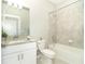 Clean bathroom with white vanity, granite countertop, and a bathtub at 19536 Fishhawk Trl, Venice, FL 34293