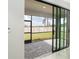 Screened-in patio featuring stone pavers and large sliding glass doors to seamlessly blend indoor and outdoor living at 19536 Fishhawk Trl, Venice, FL 34293