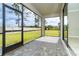 Enjoy the outdoors in this screened patio, complete with stone pavers and views of the lush green lawn at 19536 Fishhawk Trl, Venice, FL 34293