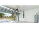 Clean and spacious garage with open overhead door, water heater, and electrical panel at 19536 Fishhawk Trl, Venice, FL 34293