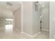 Bright interior hallway with tile floors and neutral colors at 19536 Fishhawk Trl, Venice, FL 34293