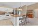 Kitchen with granite countertop island and white cabinets at 3 Pinehurst Ct, Rotonda West, FL 33947