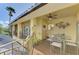 Outdoor deck with seating area and ceiling fan, overlooking the surroundings at 3060 Rivershore Ln, Port Charlotte, FL 33953
