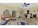 Spacious sitting room with hardwood floors, large windows, and ample natural light at 3060 Rivershore Ln, Port Charlotte, FL 33953