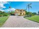 Two-story house with a large driveway and lush landscaping at 3060 Rivershore Ln, Port Charlotte, FL 33953