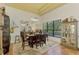 Bright dining room with a large table, chandelier, and window overlooking the backyard at 3060 Rivershore Ln, Port Charlotte, FL 33953