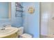 Clean bathroom with light blue walls, a shower, and a pedestal sink at 3060 Rivershore Ln, Port Charlotte, FL 33953