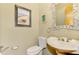 Small powder room with pedestal sink, toilet and decorative mirror at 3060 Rivershore Ln, Port Charlotte, FL 33953
