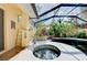 Relaxing hot tub with covered patio and tropical landscaping at 3060 Rivershore Ln, Port Charlotte, FL 33953
