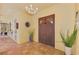 Tiled entryway with a large wooden door and potted plants at 3060 Rivershore Ln, Port Charlotte, FL 33953