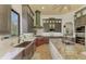 Modern kitchen with copper farmhouse sink, stainless steel appliances, and custom cabinetry at 3060 Rivershore Ln, Port Charlotte, FL 33953