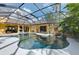 Inviting kidney-shaped pool and spa with covered patio and waterfall feature at 3060 Rivershore Ln, Port Charlotte, FL 33953