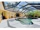 Enclosed pool and spa with covered patio and lush landscaping at 3060 Rivershore Ln, Port Charlotte, FL 33953