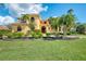 Two-story Mediterranean style home with lush landscaping at 3060 Rivershore Ln, Port Charlotte, FL 33953