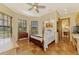 Guest bedroom with tiled floors, antique furniture, and large windows at 3060 Rivershore Ln, Port Charlotte, FL 33953