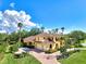 Large yellow house with tile roof and spacious driveway at 3060 Rivershore Ln, Port Charlotte, FL 33953