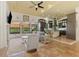 Open living room and kitchen with tile floors, high ceilings and ceiling fan at 3060 Rivershore Ln, Port Charlotte, FL 33953
