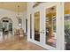 Sunroom with French doors leading to the pool and a charming seating area at 3060 Rivershore Ln, Port Charlotte, FL 33953
