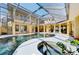 Large freeform pool and spa with covered patio and a spiral staircase at 3060 Rivershore Ln, Port Charlotte, FL 33953