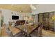 Open concept dining room adjacent to living room with tile floors and a large wooden table at 3060 Rivershore Ln, Port Charlotte, FL 33953